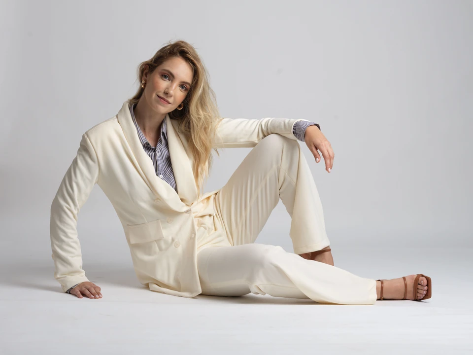 Model wearing a cream suit and striped shirt