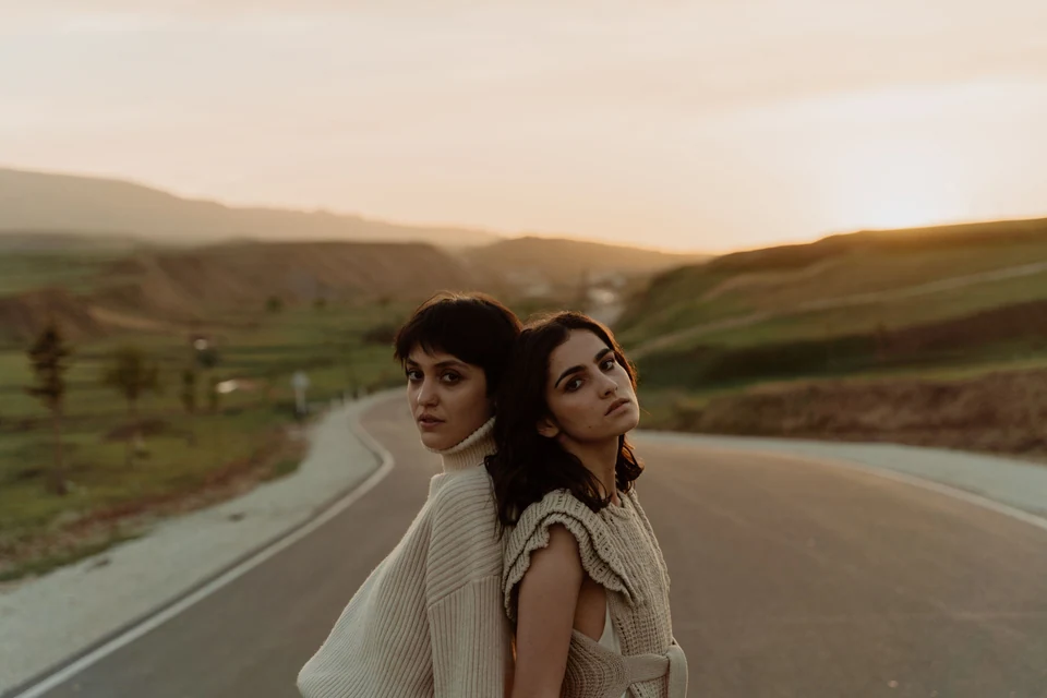 Models wearing a neutral knitwear collection